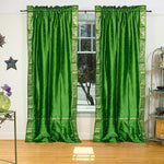 Forest green sari rod pocket curtains hung at a window