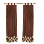 Brown sari tab top curtains hung at a window