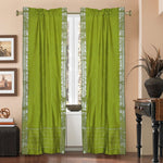 Olive green sari rod pocket curtains hung at a window