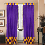 Purple sari tab top curtains hung at a window