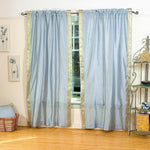 Gray sari rod pocket curtains hung at a window