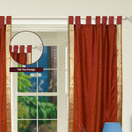 Rust sari tab top curtains hung at a window