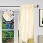 Cream sari rod pocket curtains hung at a window
