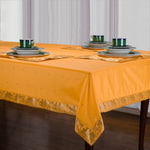 Yellow sari tablecloth laid on a dining table