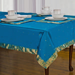 Turquoise sari tablecloth laid on a dining table