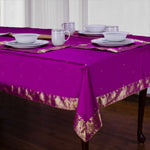 Violet sari tablecloth laid on a dining table