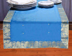 Turquoise silk table runner running down a dining table
