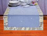 Gray silk table runner running down a dining table