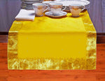Yellow silk table runner running down a dining table