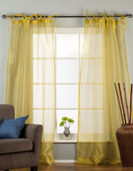 Sheer tissue tie top curtains hung at a window