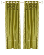 Olive green sari grommet top curtains hung at a window