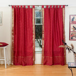 Maroon sari tab top curtains hung at a window