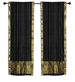 Black sari rod pocket curtains hung at a window