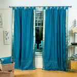 Turquoise sari tab top curtains hung at a window