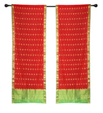Red sari rod pocket curtains hung at a window
