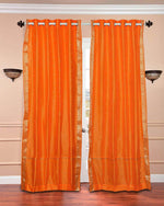 Pumpkin sari grommet top curtains hung at a window