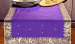 Regal purple silk table runner running down a dining table