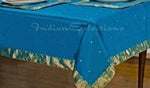 Turquoise sari tablecloth laid on a dining table