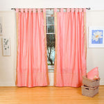 Pink sari tab top curtains hung at a window