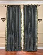 Grey sari grommet top curtains hung at a window