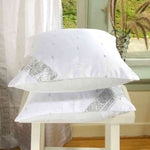 White sari cushion covers arranged on a sofa