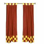 Yellow sari tab top curtains hung at a window