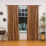 Taupe velvet rod pocket curtains hung at a window