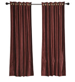 Wine velvet grommet top curtains hung at a window