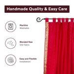 Maroon sari tab top curtains hung at a window