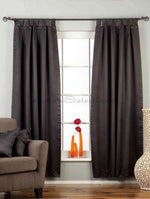 Black sari tab top curtains hung at a window