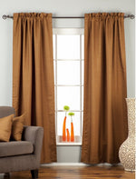 Brown raw silk rod pocket curtains hung at a window