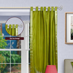 Olive green sari tab top curtains hung at a window