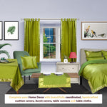 Olive green sari tab top curtains hung at a window