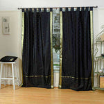 Black sari tab top curtains hung at a window
