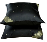 Black sari cushion covers arranged on a sofa
