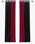 Burgundy velvet ring top curtains hung at a window