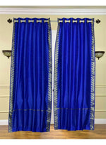 Blue sari grommet top curtains hung at a window