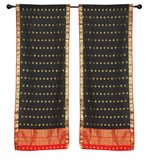 Black sari rod pocket curtains hung at a window