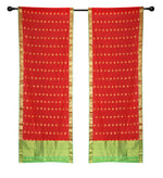Red sari rod pocket curtains hung at a window