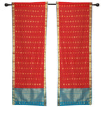 Red sari rod pocket curtains hung at a window