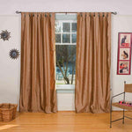 Taupe velvet tab top curtains hung at a window