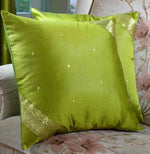 Olive green sari cushion covers arranged on a sofa