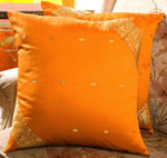 Earthy mustard sari cushion covers arranged on a sofa