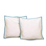 Turquoise raw silk cushion covers arranged on a sofa