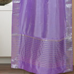 Lavender sari rod pocket curtains hung at a window