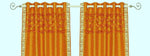 Mustard sari grommet top curtains hung at a window