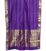 Purple sari rod pocket curtains hung at a window