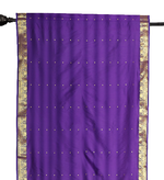 Purple sari rod pocket curtains hung at a window