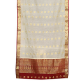 Cream sari rod pocket curtains hung at a window
