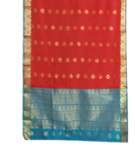 Red sari rod pocket curtains hung at a window